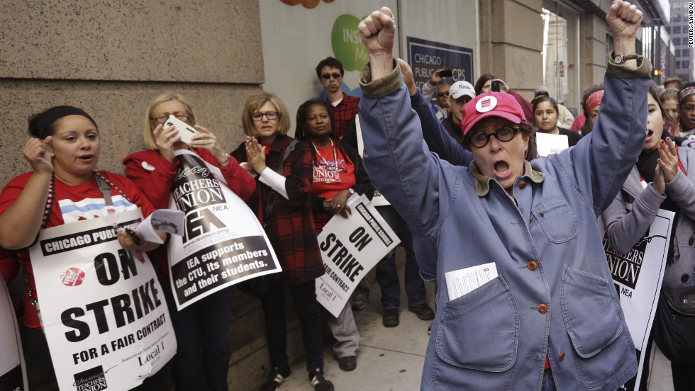 Chicago Teachers Union members picket outside Chicago Public Schools headquarters Tuesday, September 18, as their strike canceled classes for a seventh day. School officials went to court Monday to ask a judge to declare the strike illegal and order the teachers back to work. Union representatives reconvened Tuesday afternoon to discuss a proposed deal.