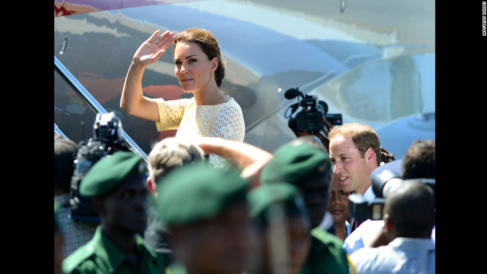 Catherine, Duchess of Cambridge, waves goodbye to onlookers as she and Prince William board a plane to leave the Solomon Islands from Honiara on Tuesday, September 18.