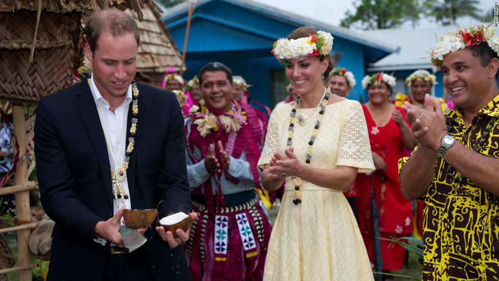 Prince William opens a coconut with a machete as Catherine, Duchess of Cambridge, watches on Tuesday in Tulavu.