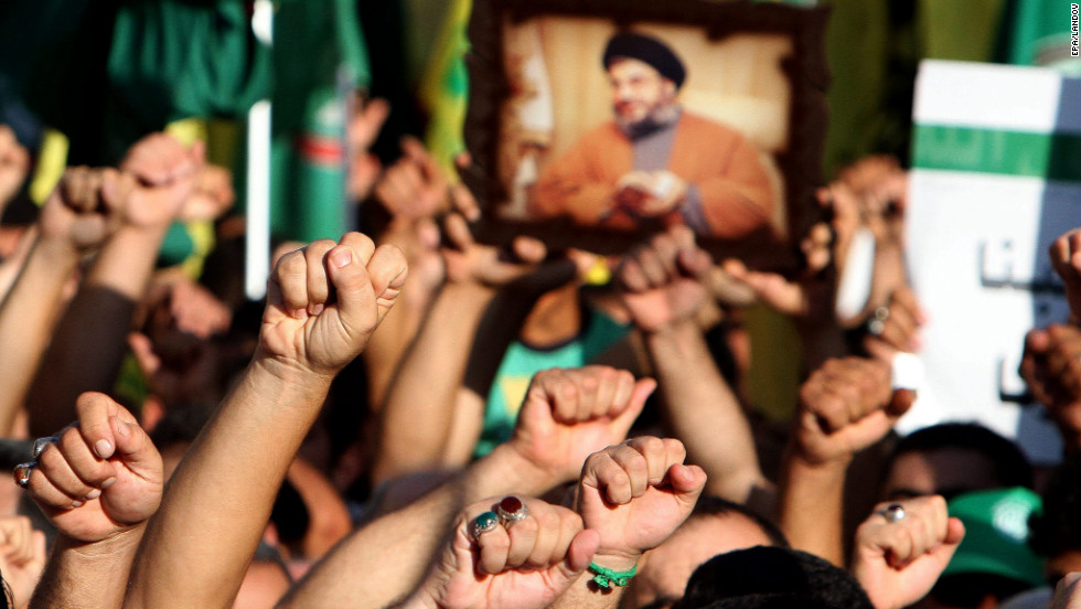 Supporters of Hezbollah hold a picture depicting Hezbollah leader Hassan Nasrallah and chant the slogan &quot;God is Great&quot; during a mass rally in Tyre, Lebanon, on Wednesday. Thousands of Lebanon&#39;s Hezbollah followers protested against the United States and France for a film and cartoons mocking the Prophet Mohammed. 