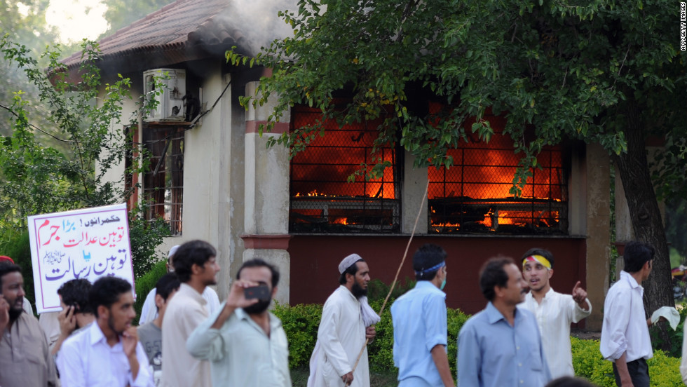 Pakistani protesters walk near a burning police bunker as demonstrators attempt to reach the U.S. Embassy in Islamabad on Thursday, September 20.