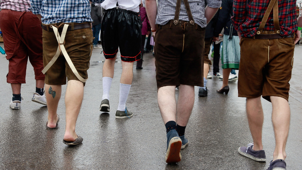 Revelers wearing different types of mock lederhosen walk at the festival.