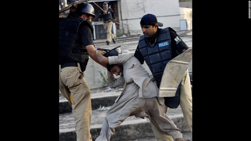 Pakistani police detain a demonstrator in Lahore on Friday during a protest against the film &quot;Innocence of Muslims.&quot;