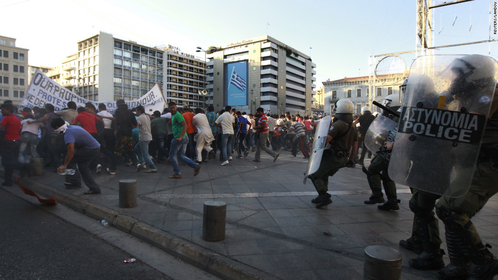 Riot police try to disperse Muslim protesters in Athens on Sunday.