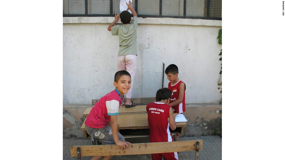 Children taking pencil rubbings as part of a &quot;textures of the city&quot; project through Art Camping in Aleppo on August 13, a few days before fighting reached the city center.