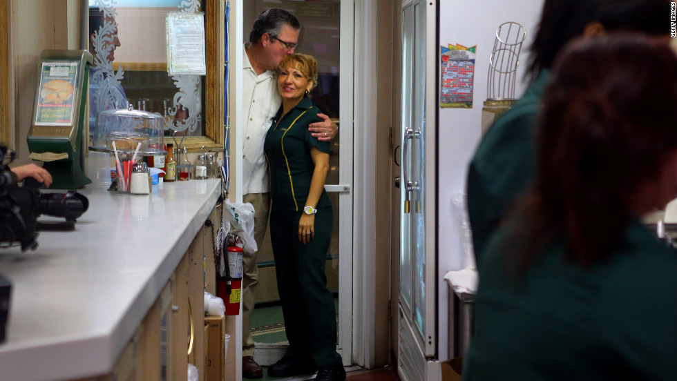 Former Florida Gov. Jeb Bush hugs a waitress as they wait for Ryan&#39;s arrival during a campaign stop at a restaurant in Miami&#39;s Little Havana neighborhood on Saturday, September 22.