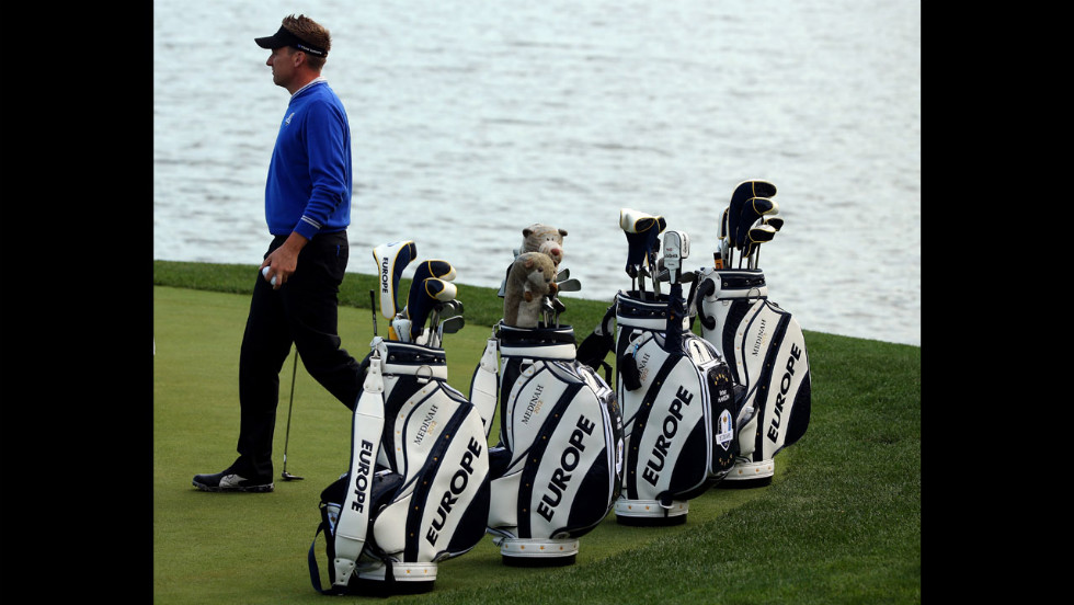 Ian Poulter of Europe practices near his teammates&#39; golf bags Wednesday.
