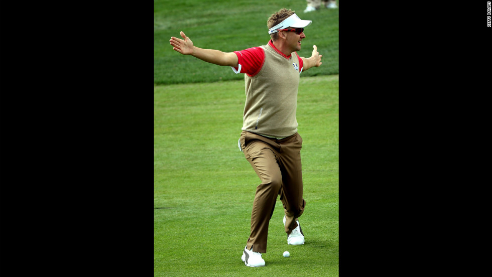 Ian Poulter of Europe stands over a ball in the fairway Thursday.