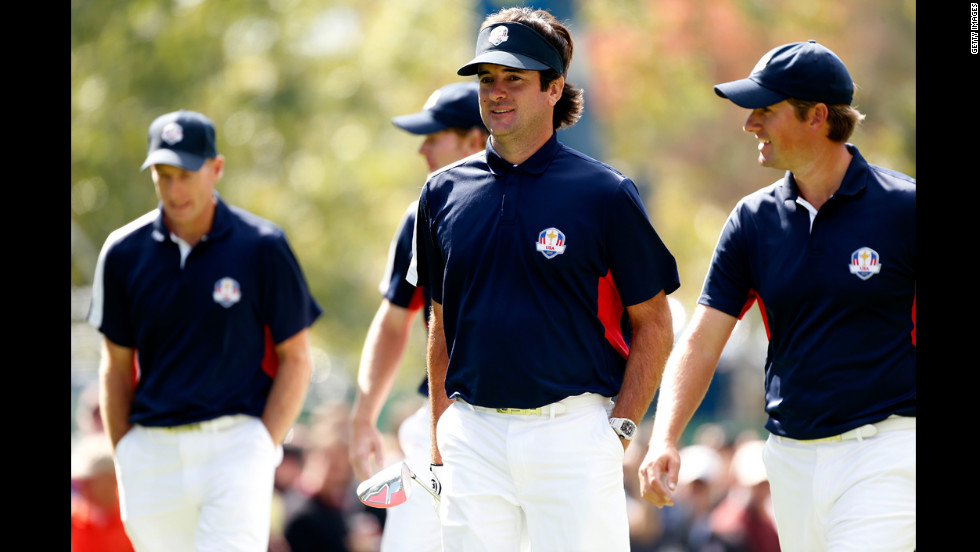 2012 Masters champion Bubba Watson, center, walks with U.S. teammate and U.S. Open winner Webb Simpson during a practice round Thursday.