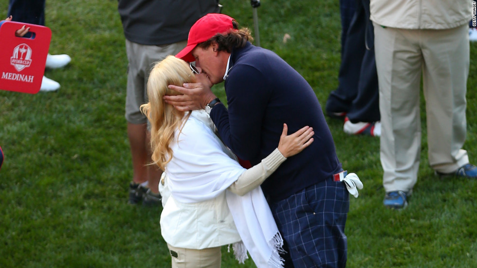 Phil Mickelson of the United States kisses his wife Amy on the first tee Friday.