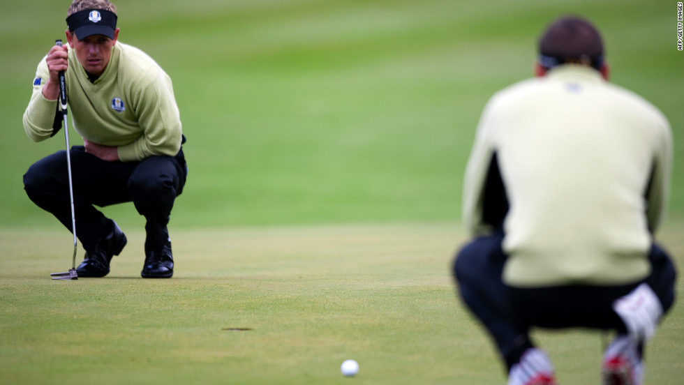 Luke Donald of England, left, and Sergio Garcia of Spain look over their putt on the sixth hole Friday.