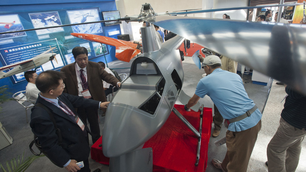 Chinese visitors examine an unmanned helicopter drone at the China Aviation Expo in Beijing on September 21, 2011.