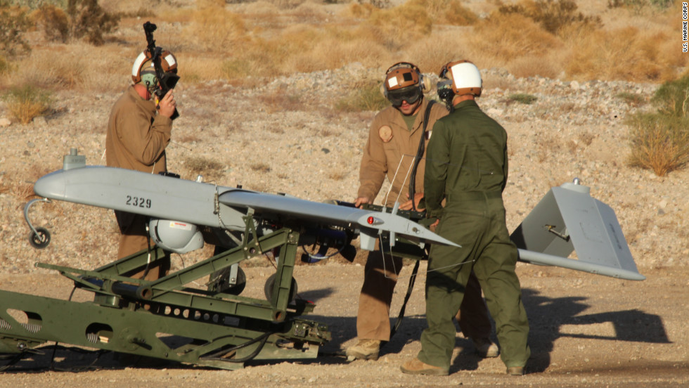 U.S. Marines perform operational checks on a Marine Squadron Two (VMU-2) UAV before a launch at Speed Bag Airfield, near Niland, California, on October 25, 2011.  