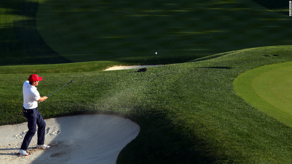 Keegan Bradley of the USA hits out of the bunker on the 16th green after defeating Rory McIlroy and Graeme McDowell on Friday, September 28. 