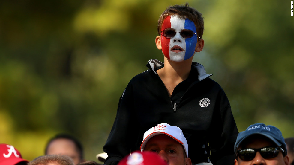 A fan of the U.S. golfers watches the action.