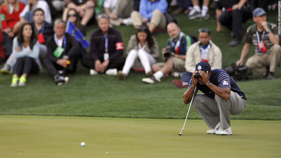 Tiger Woods of the United States scopes out a putt on the 17th hole during four-ball play Saturday.