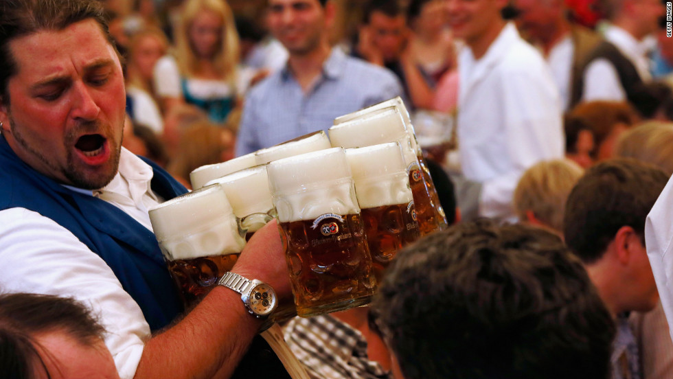 A waiter carries beer mugs through the Braeurosl beer tent during day seven of Oktoberfest 2012 on Friday, September 28, in Munich. 