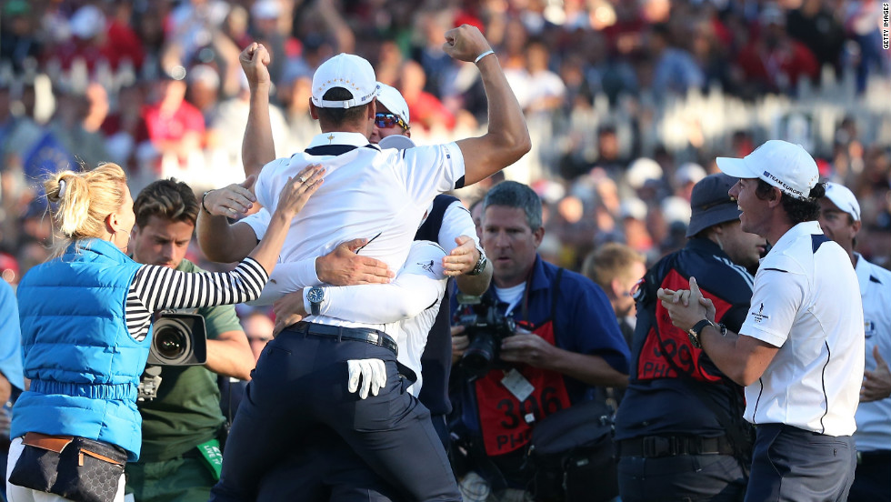 Martin Kaymer is mobbed by the European team after he made the winning putt on the 18th green on Sunday to cinch the Ryder Cup.