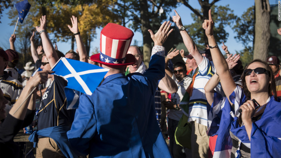 A U.S. fan high-fives Team Europe&#39;s fans after their Ryder Cup victory on Sunday.