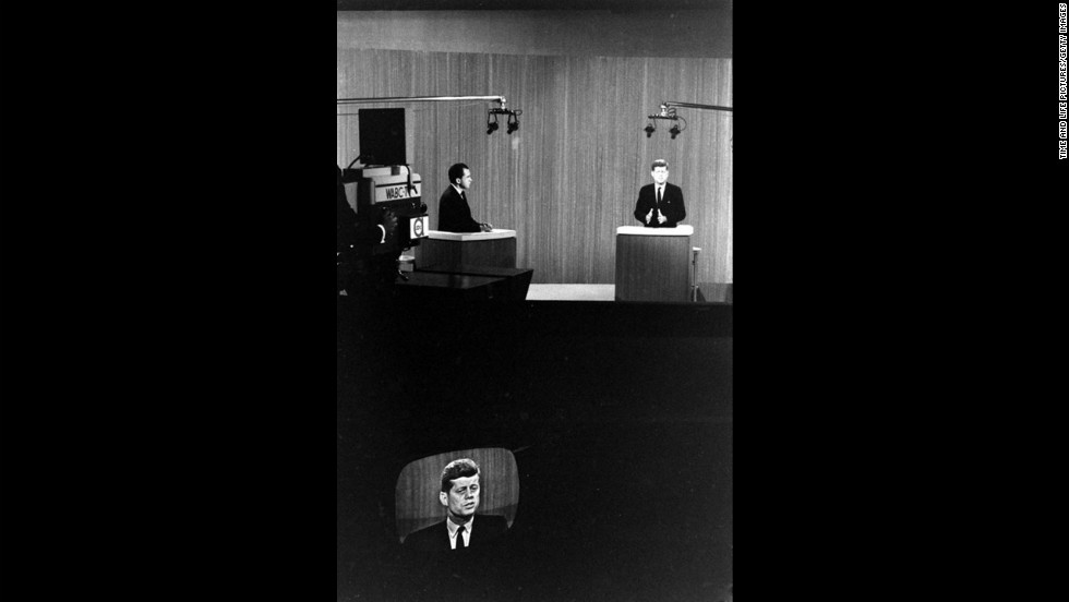 Kennedy and Nixon debate at their lecterns.