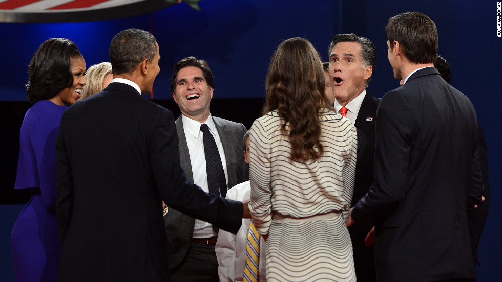 Michelle and Barack Obama, left, join Mitt Romney and his family at the conclusion of the first presidential debate.