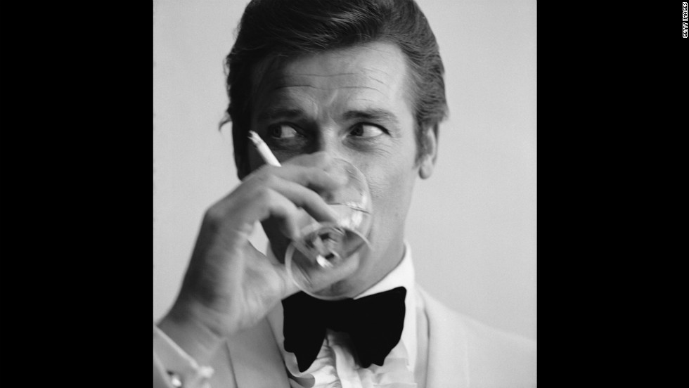 Roger Moore drinks a martini, James Bond&#39;s signature drink.