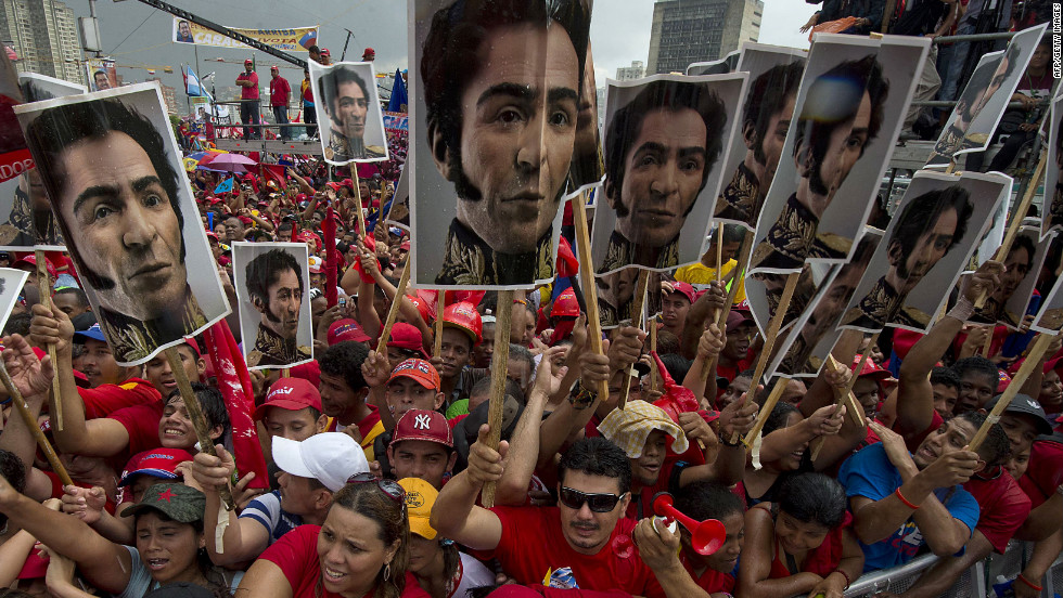 Chavez supporters hold photos of Simon Bolivar, who led Venezuela&#39;s fight for independence from Spain in the 1820s, during Chavez&#39;s campaign wrap-up rally in Caracas on Thursday, October 4.