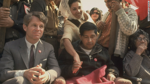 Robert F. Kennedy sits next to Cesar Chavez, looking very weak after prolonged hunger strike, during a rally in support of the United Farm Workers Union.