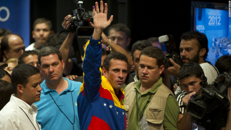 Opposition candidate Henrique Capriles Radonski waves to supporters Sunday night in Caracas after learning of his defeat. During the campaign, he criticized the Chavez administration for inefficiencies, infrastructure shortcomings and corruption.
