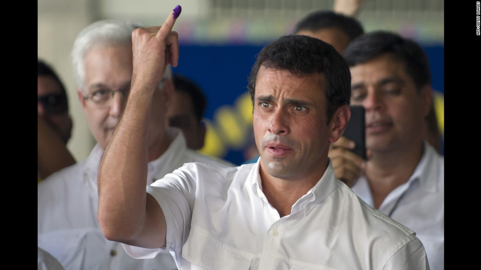 Opposition candidate Henrique Capriles Radonski shows his finger after voting Sunday in Caracas. With 90% of the ballots counted Sunday night, Chavez won 54.42% of the vote, compared with 44.97% for Capriles, according a National Electoral Council official.