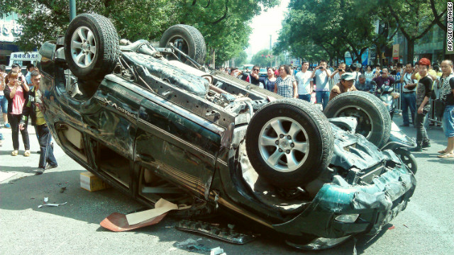 People taking pictures of a Japanese-brand car damaged during a protest against Japan in the Chinese city of Xian in 2012.