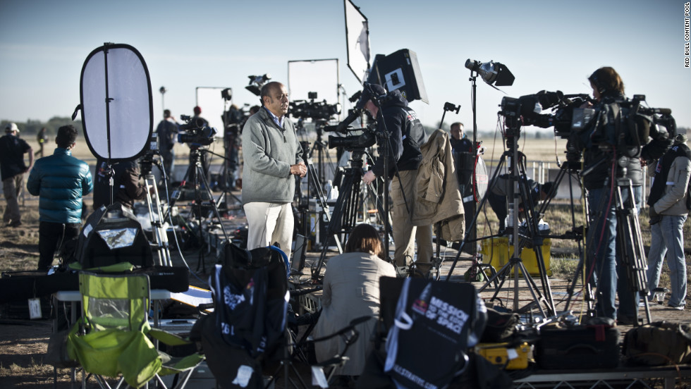 TV crews report from the launch site.