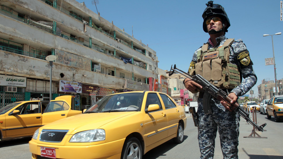 An Iraqi policeman stands guard at a checkpoint in central Baghdad. It has been 10 months since U.S. combat troops left, but it is far from peace time in Iraq.