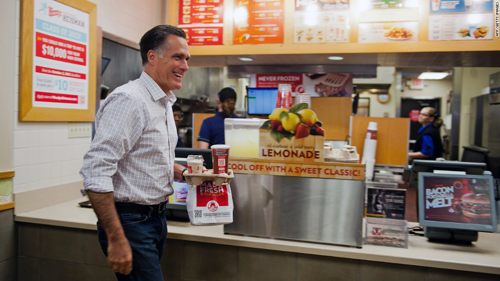 Republican presidential candidate Mitt Romney departs a Wendy&#39;s restaurant with his dinner order in Cuyahoga Falls, Ohio, on Tuesday. 