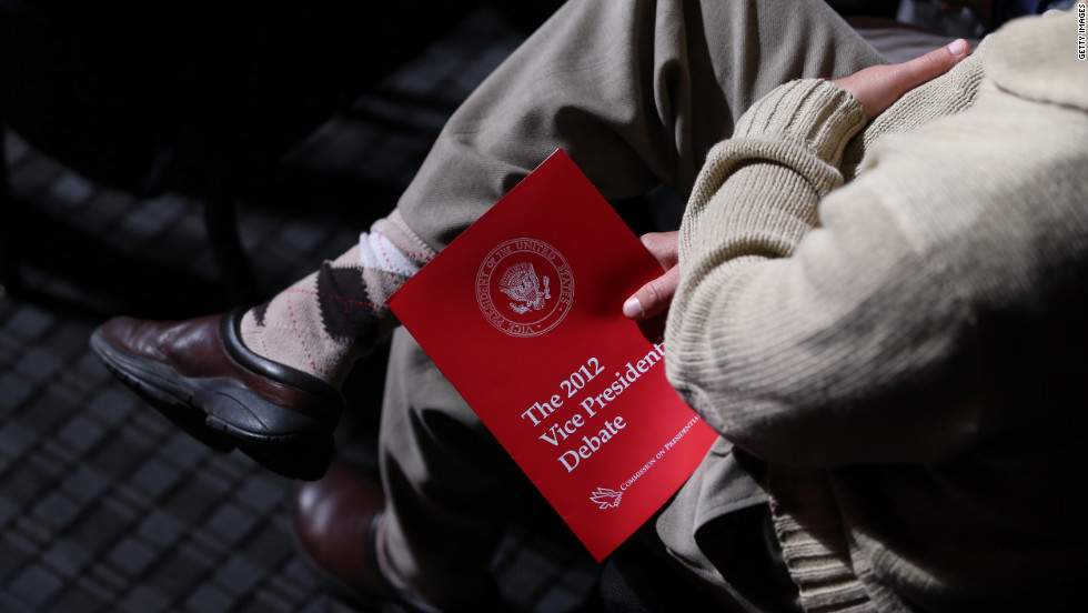 An audience member holds a debate program.