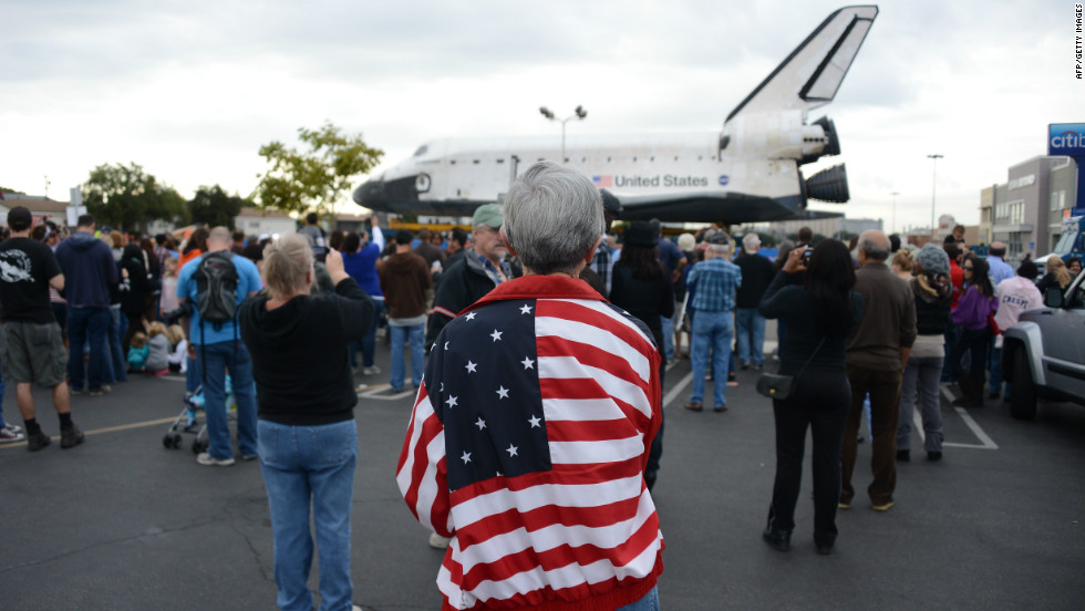 Spectators come to watch the space shuttle Endeavour as it rests at Westchester Square during its final ground journey in Los Angeles on Friday.