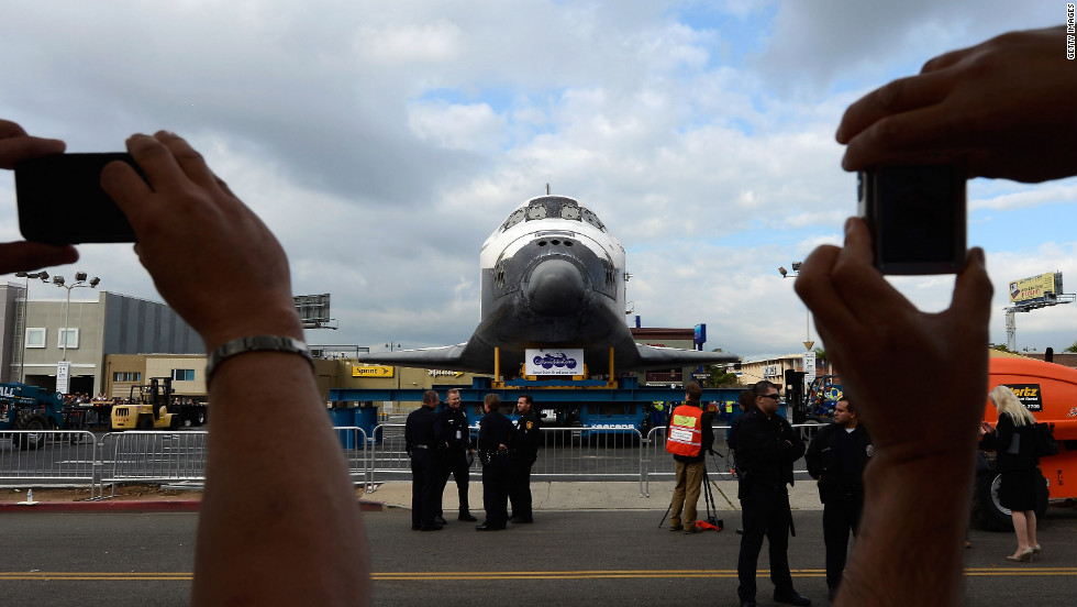 Spectators take pictures of Endeavour during its journey through Los Angeles.