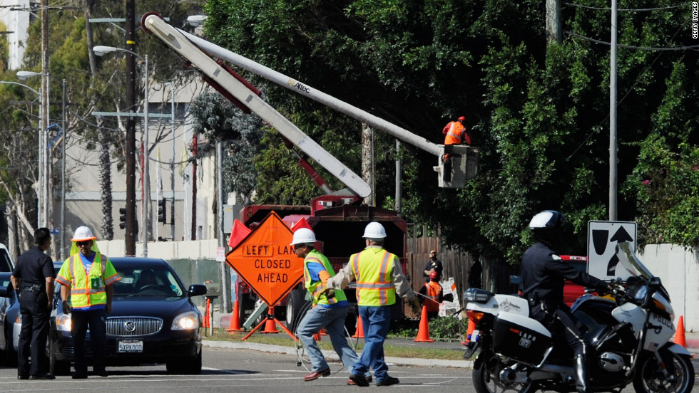 Tree trimmers cut large branches of a tree that was protruding toward the street in a last-minute effort to clear hurdles along the space shuttle Endeavour&#39;s route on Friday.