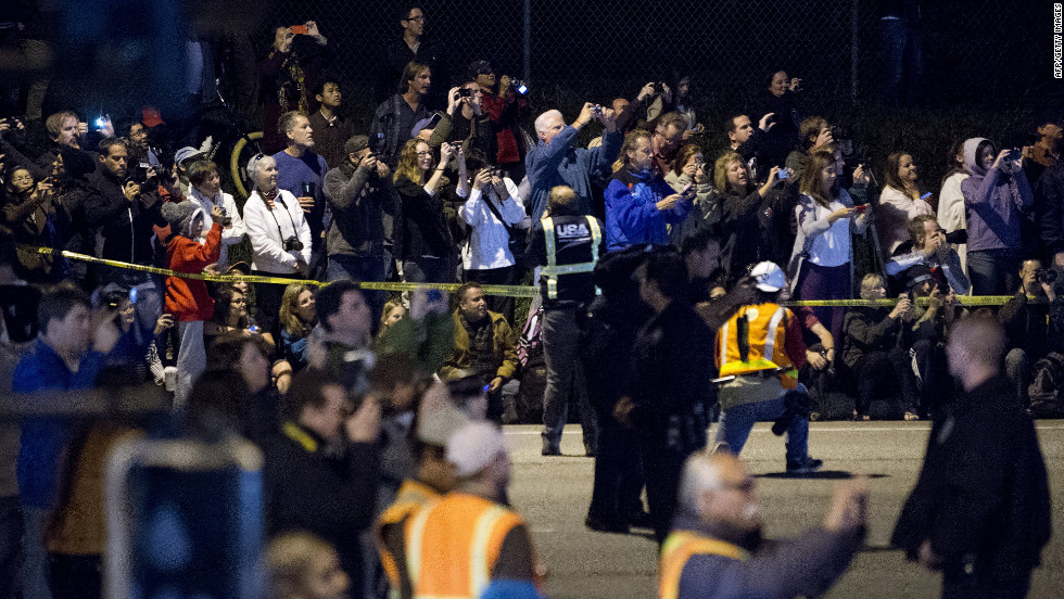 Spectators take pictures of the shuttle Friday at the Los Angeles airport. Once it reaches the science museum, the shuttle will be on display for posterity. It had its first launch in 1992.