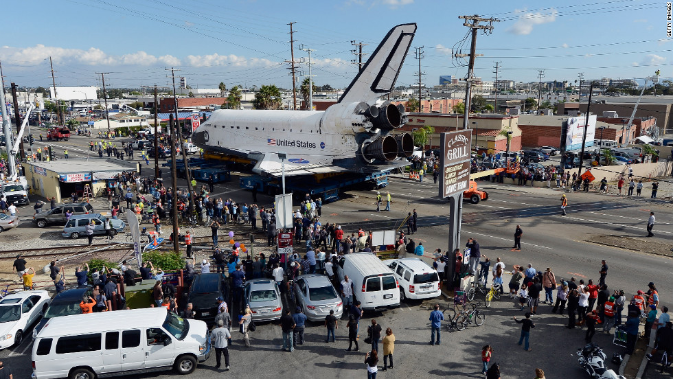 Endeavour moves down a main road lined with onlookers. Endeavour was flown cross-country atop NASA&#39;s Shuttle Carrier Aircraft from Kennedy Space Center in Florida to LAX on September 21.