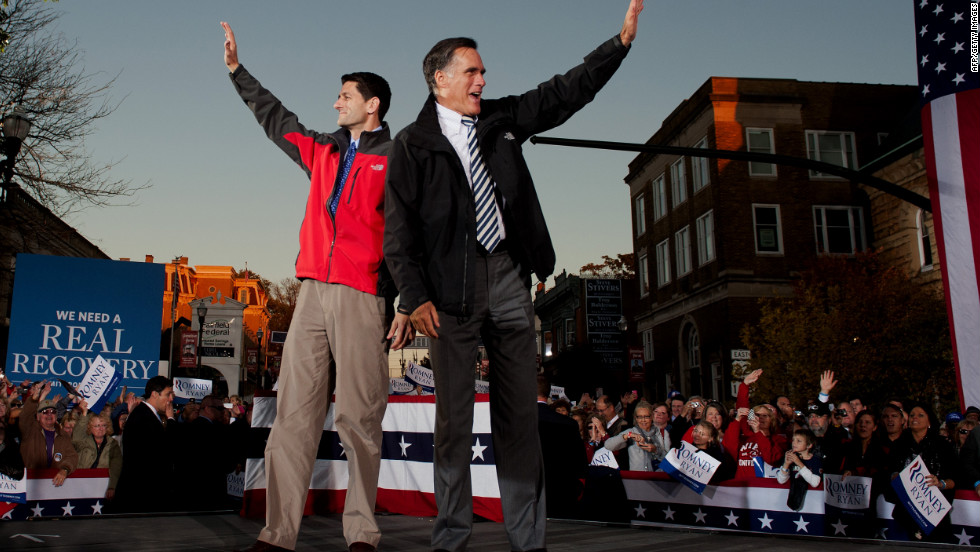 Romney, right, and GOP vice-presidential candidate Paul Ryan greet supporters as they arrive at a rally in Lancaster, Ohio, on Friday.