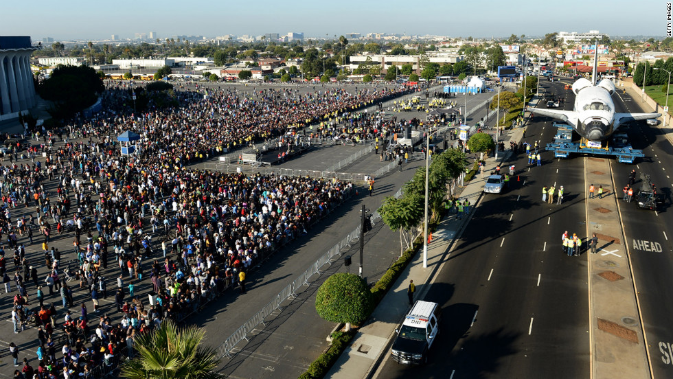 People watch as the craft arrives at The Forum on its way to the California Science Center on Saturday.