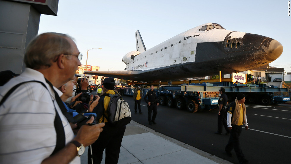 Endeavour is on its last mission: a 12-mile creep through city streets, past an eclectic mix of strip malls, mom-and-pop shops, tidy lawns and faded apartment buildings. 