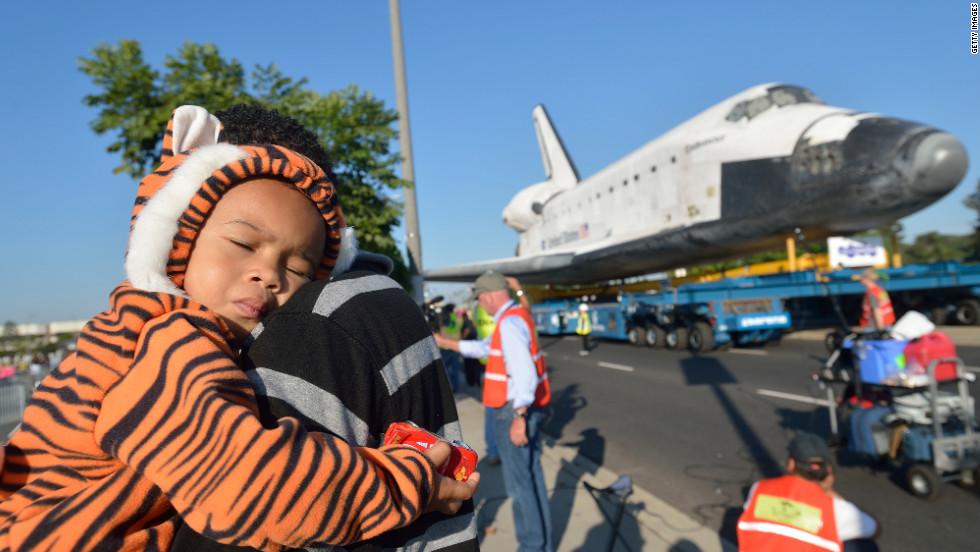 Mikael Ector, 2, tries to get some rest as his dad, Michael Ector, checks out Endeavour as it arrives at the Forum on Saturday.