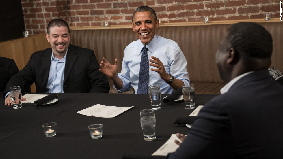 Mario Orosa, left, and Ron Cathey, right, chat with Obama during dinner at Smith Commons restaurant in Washington on Friday, October 12. Obama had dinner with contest winners who contributed to his re-election campaign. 