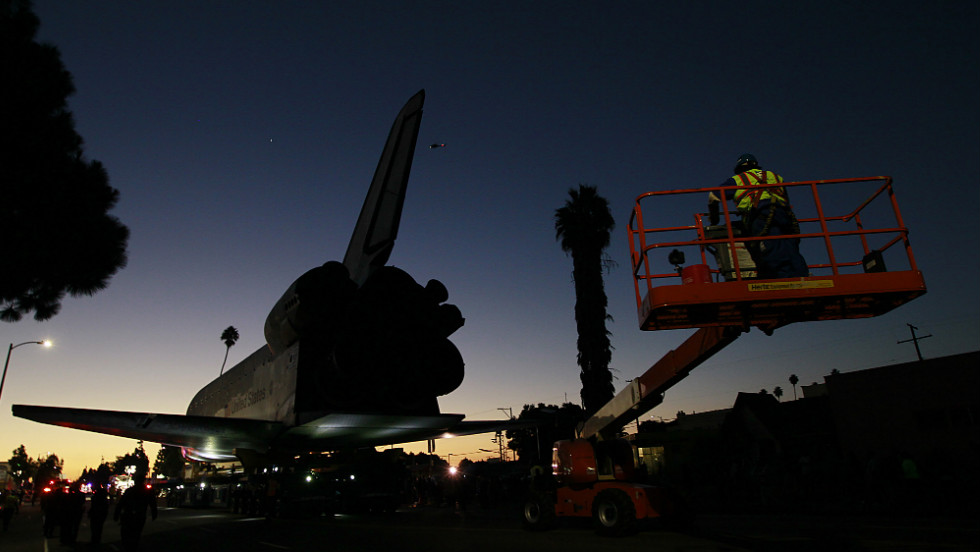 The sun rises as the space shuttle Endeavour slowly moves along Martin Luther King Boulevard to the California Science Center on Sunday.