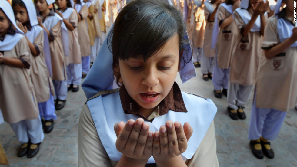 Pakistani school girls pray for the recovery of teen activist Malala Yousufzai at their school in Peshawar.