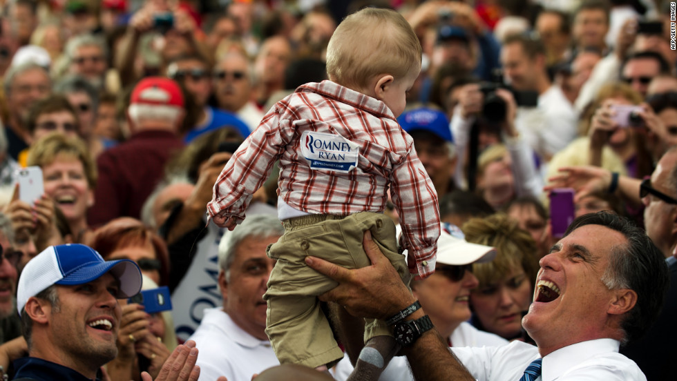 Romney holds up a baby as he works the rope line after delivering remarks at a rally in Lebanon, Ohio, on Saturday, October 13.