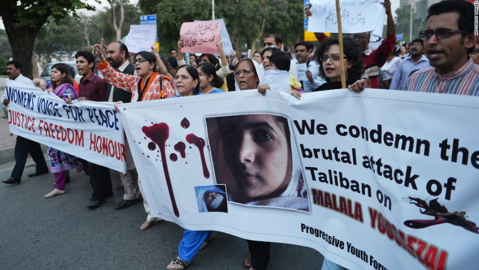 Pakistani civil society activists carry banners in Islamabad on Wednesday as they shout ant-Taliban slogans during a protest against the assassination attempt.