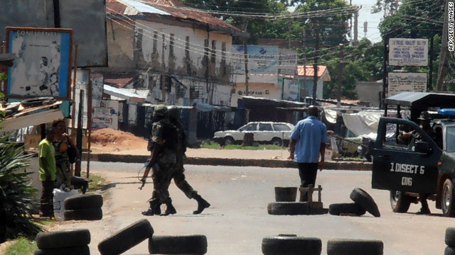 Military escort women out of Kaduna, Nigeria, on June 19, after rioting that broke out after religious violence left over 50 dead.